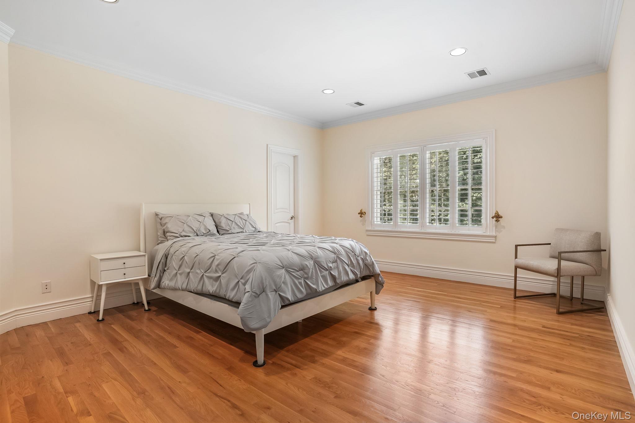 4 Hageman Court Katonah, NY 10536 - Photo 29 of 47 a spacious bedroom with a bed and wooden floor