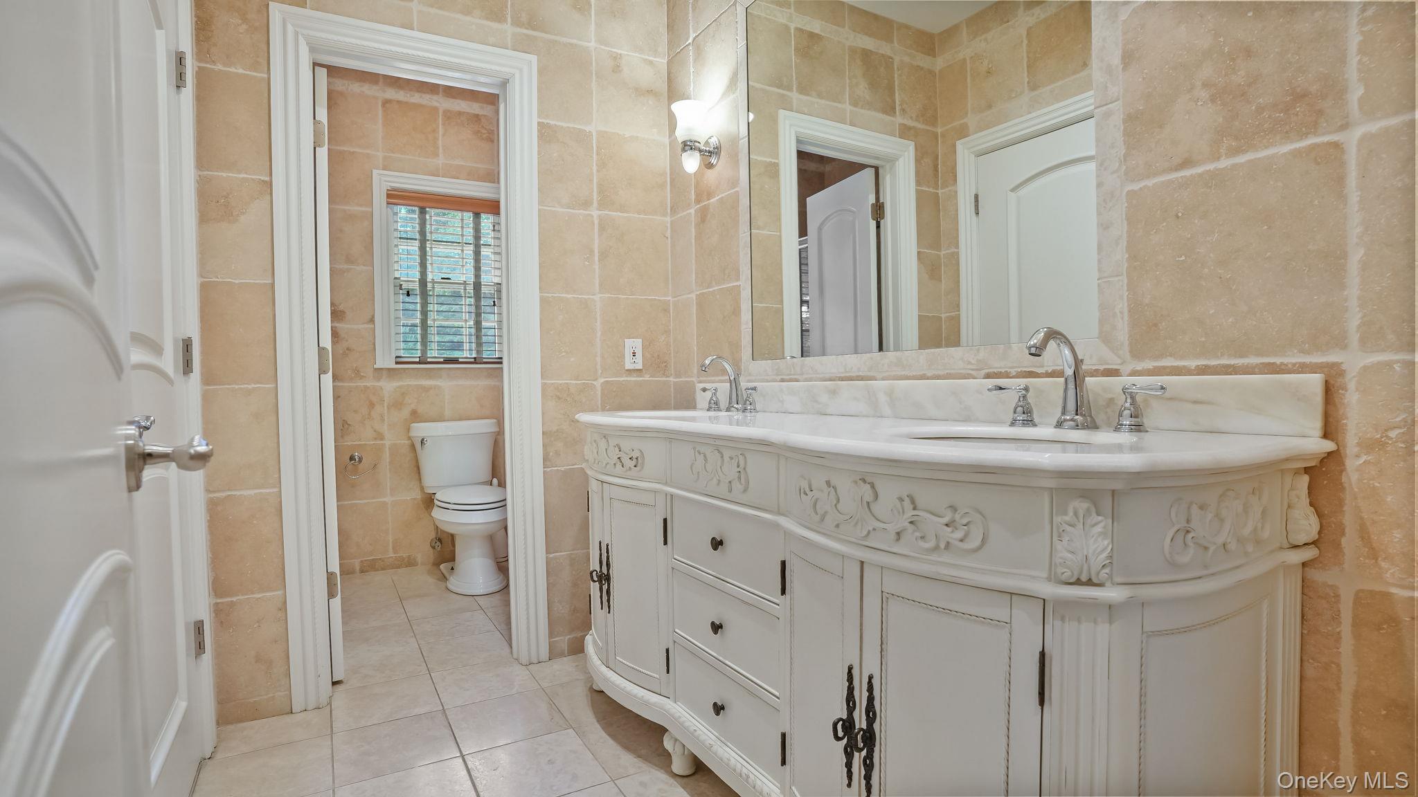 4 Hageman Court Katonah, NY 10536 - Photo 32 of 47 a bathroom with a granite countertop sink a mirror and a shower