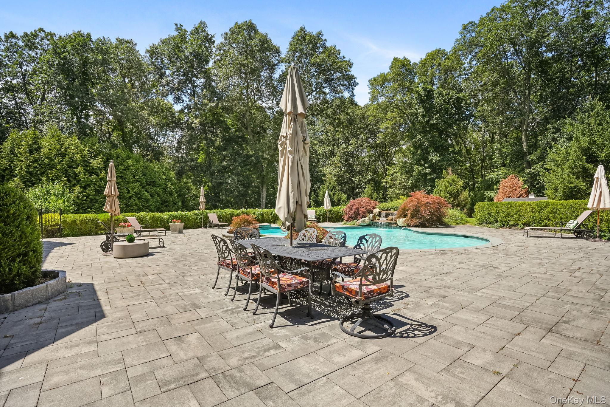 4 Hageman Court Katonah, NY 10536 - Photo 37 of 47 a view of a patio with a table chairs and a fire pit