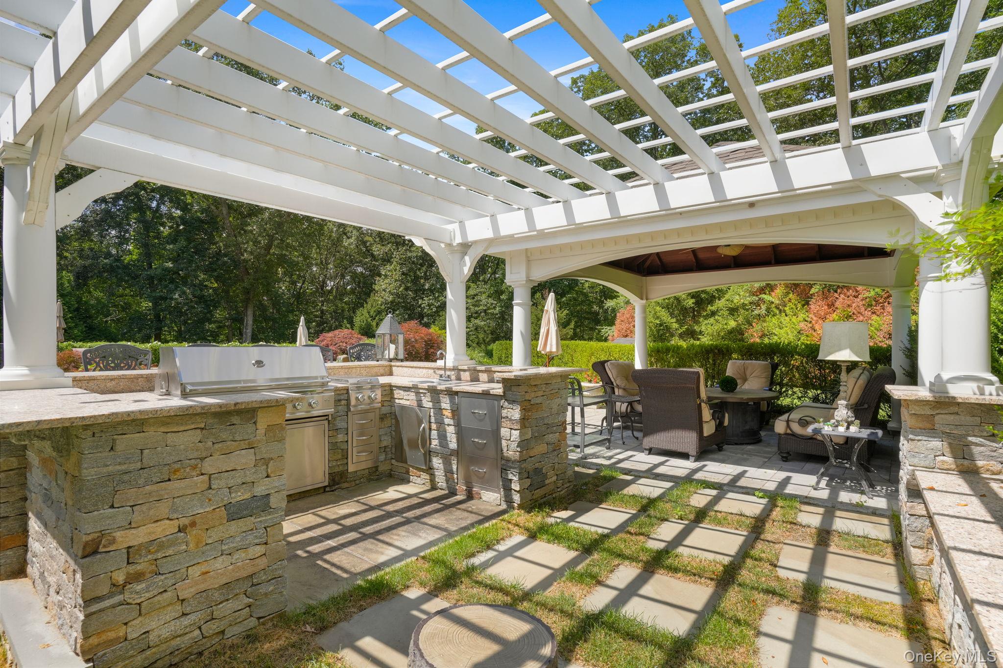 4 Hageman Court Katonah, NY 10536 - Photo 41 of 47 a view of a patio with lawn chairs next to a yard