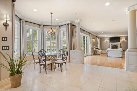 a living room with furniture a large window and a chandelier