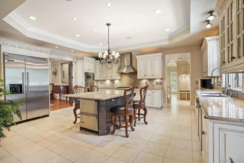 a large kitchen with a table and chairs