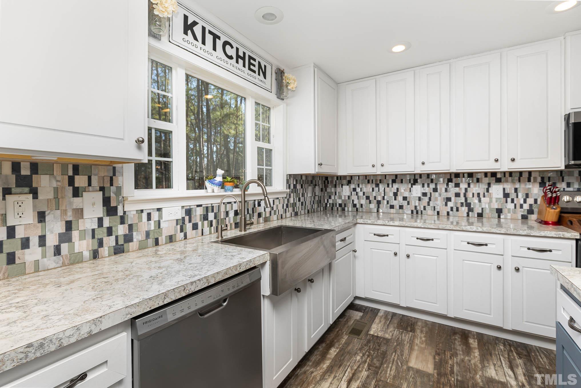 2917 Edgemont Road Wendell, NC 27591 - Photo 13 of 27 a kitchen with granite countertop a sink a stove and cabinets