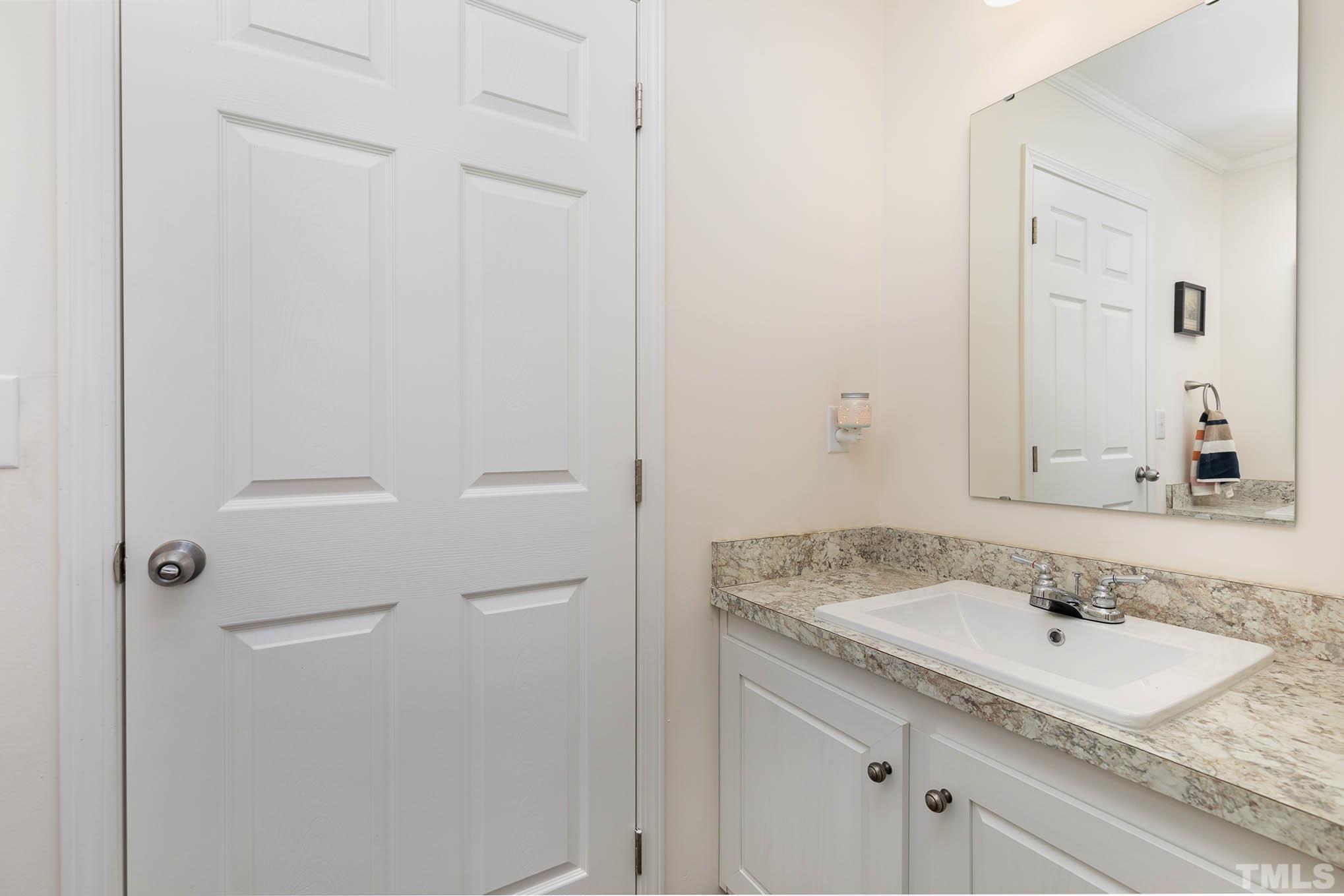 2917 Edgemont Road Wendell, NC 27591 - Photo 24 of 27 a bathroom with a granite countertop sink and a mirror