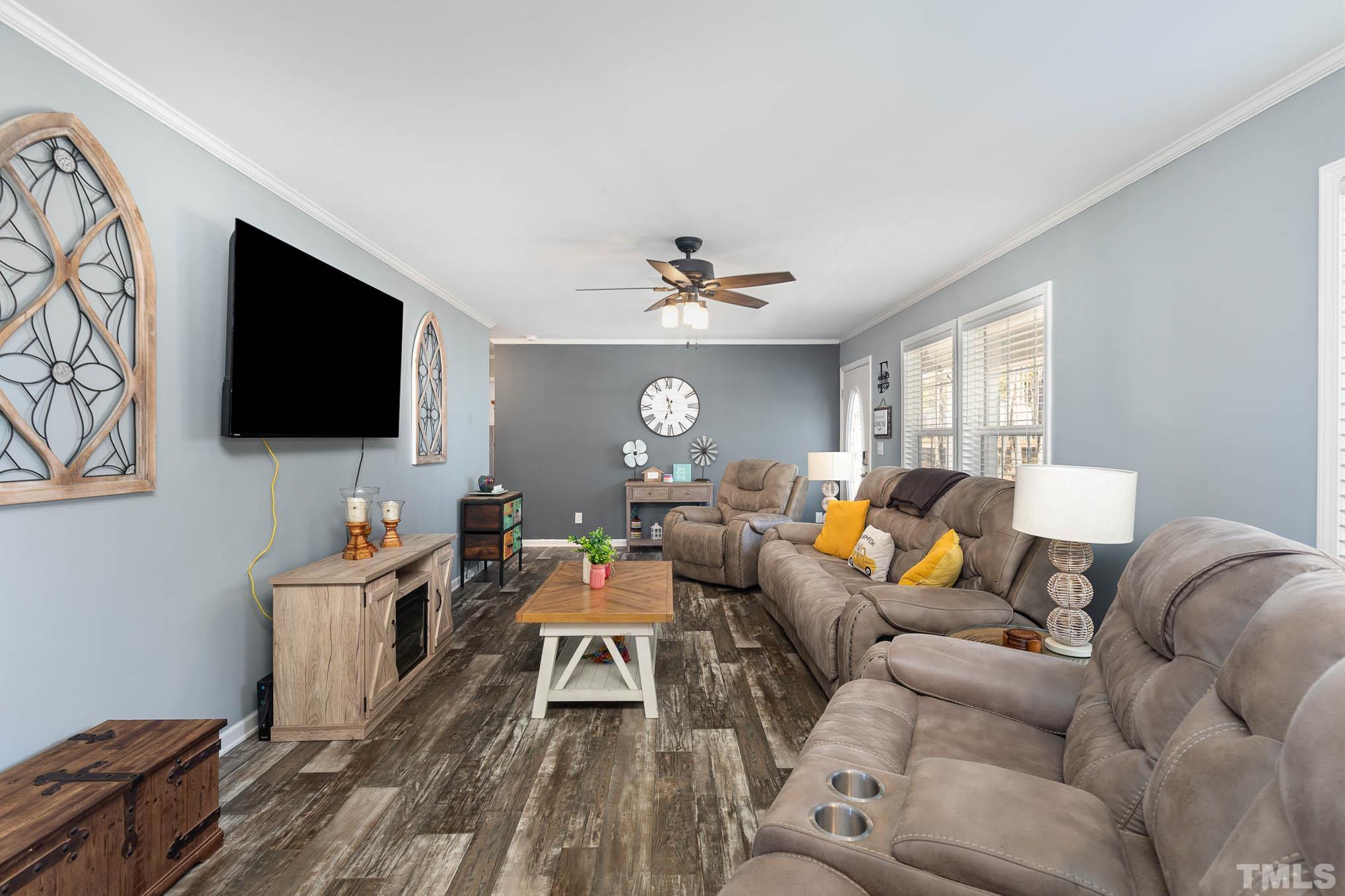 2917 Edgemont Road Wendell, NC 27591 - Photo 6 of 27 a living room with furniture and a flat screen tv