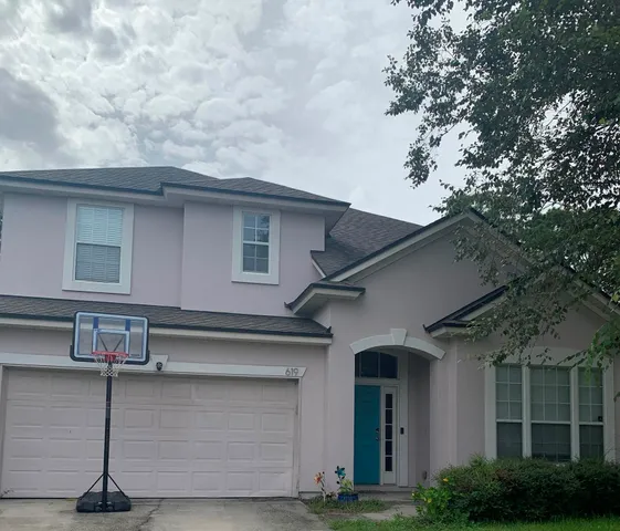 a front view of a house with garage