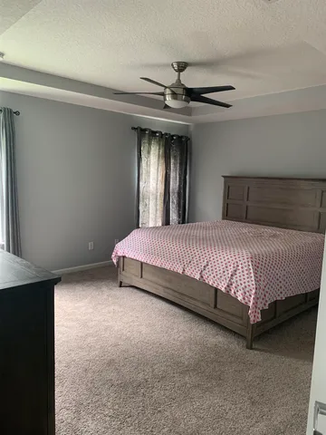 a bed sitting in a room next to a window