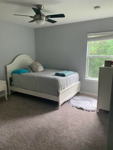 a bed sitting in a room next to a window