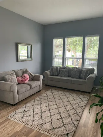 a living room with furniture and a window