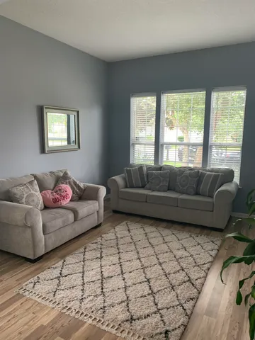 a living room with furniture and a window