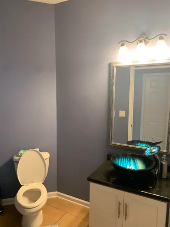 a bathroom with a toilet and a mirror