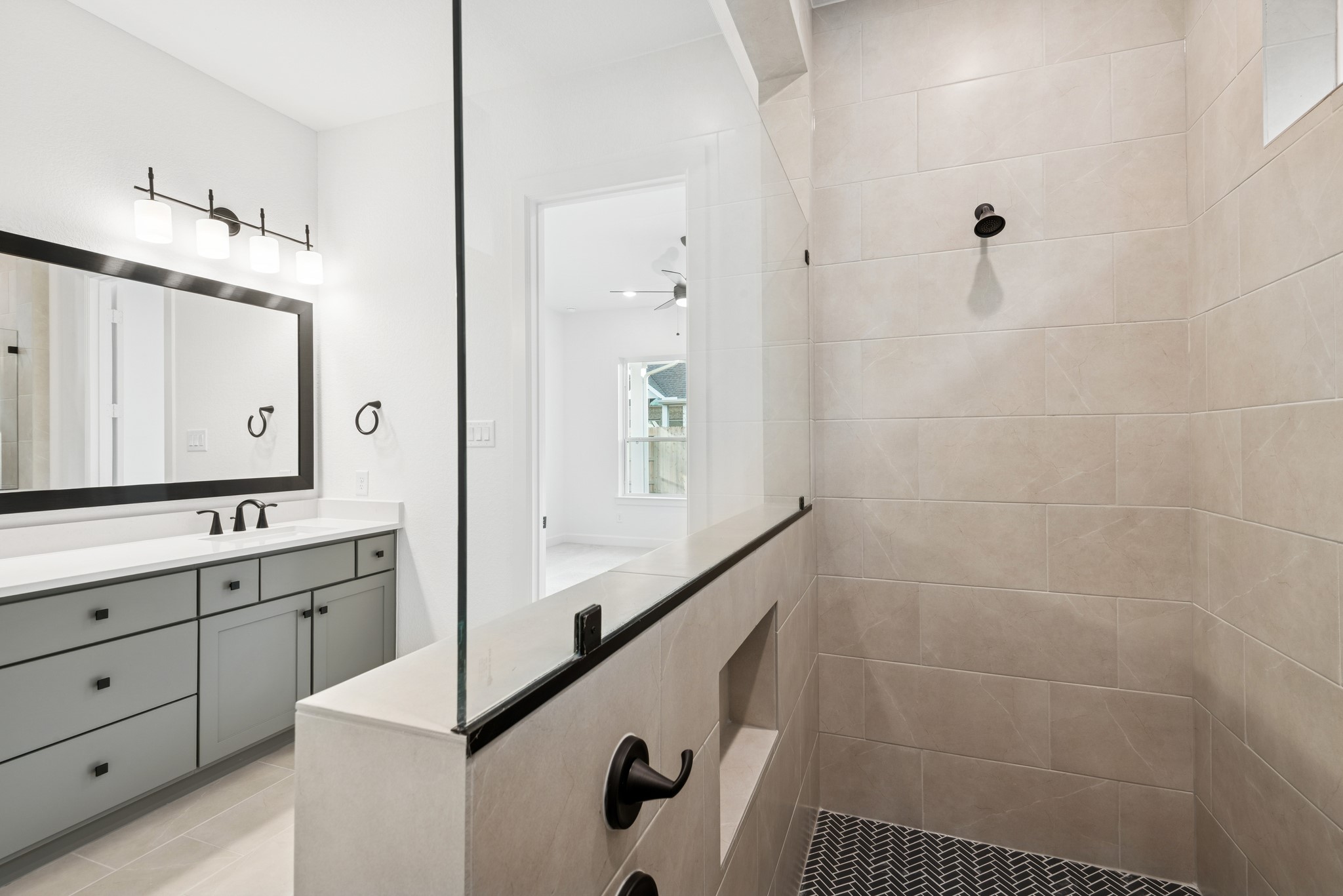 15714 Terracotta Terrace Lane Conroe, TX 77302 - Photo 39 of 47 a bathroom with a double vanity sink a mirror and a shower