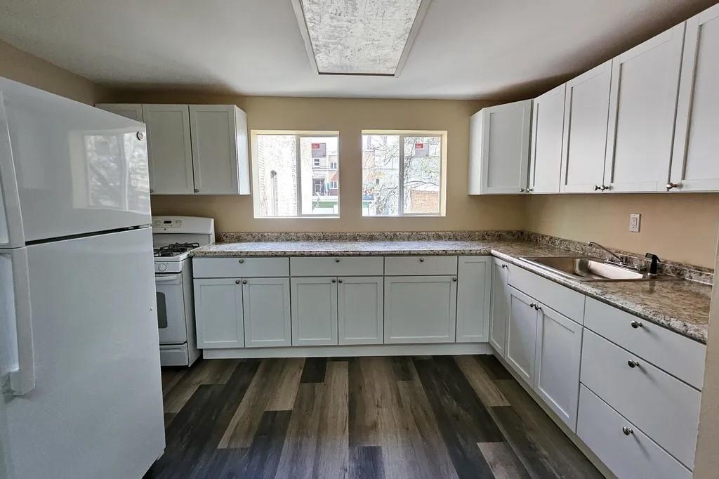 5154 Butler Street Pittsburgh, PA 15201 - Photo 6 of 10 a kitchen with a sink window and cabinets