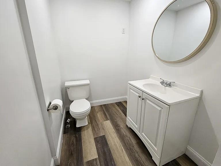 5154 Butler Street Pittsburgh, PA 15201 - Photo 10 of 10 a bathroom with a sink a toilet and a mirror