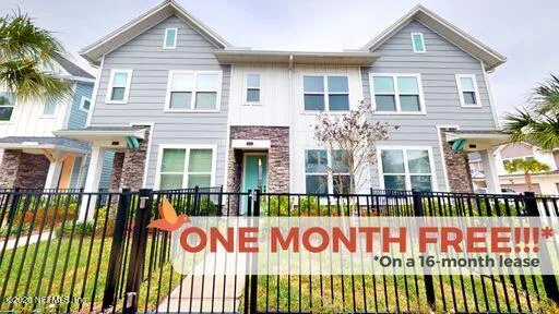 a front view of a building with a garden and plants