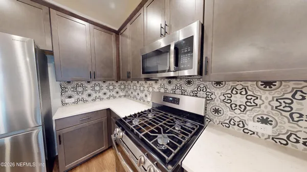 a kitchen with a stove and a refrigerator
