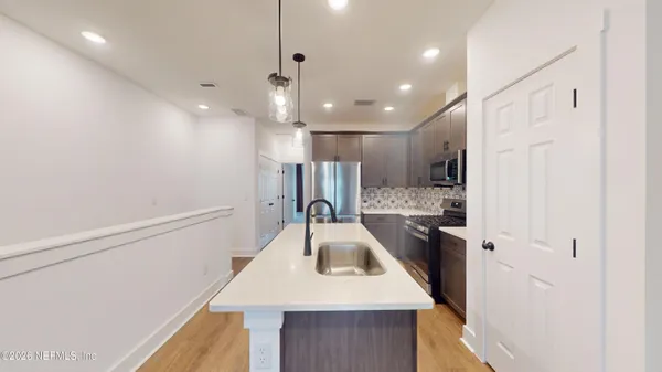 a kitchen with a refrigerator a sink and a refrigerator