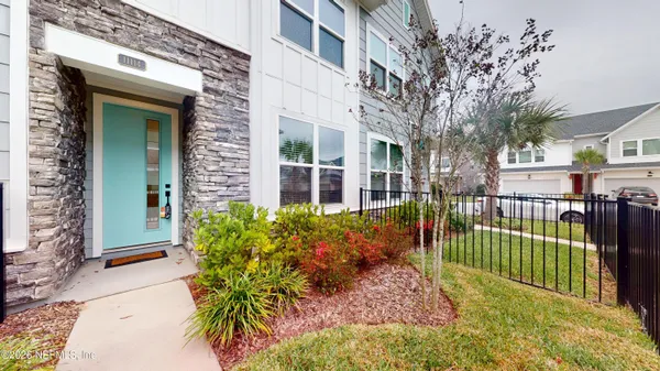 a view of a house with a flower garden