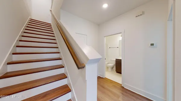 a view of entryway and hall with wooden floor
