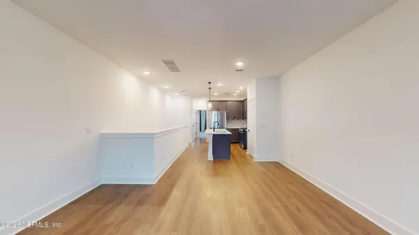 a view of a room with wooden floor