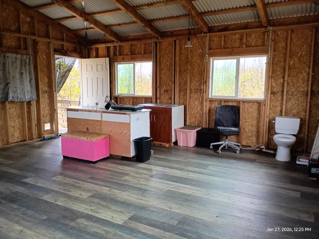 a living room with furniture and wooden floors