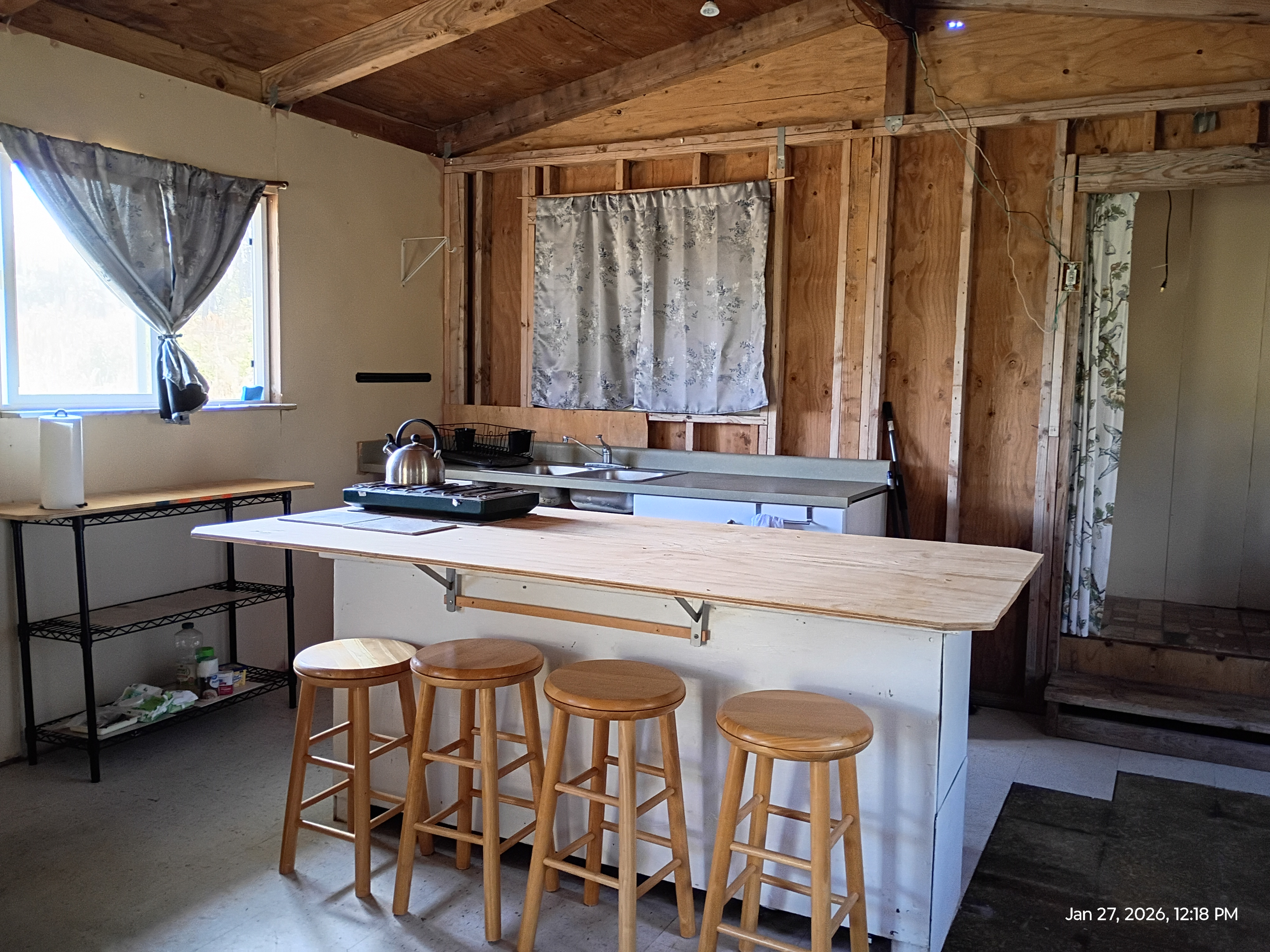 11-2311 Kaleponi Road Mountain View, HI 96771 - Photo 4 of 28 a kitchen with a table chairs sink and cabinets