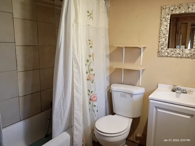 a white toilet sitting next to a bathroom sink