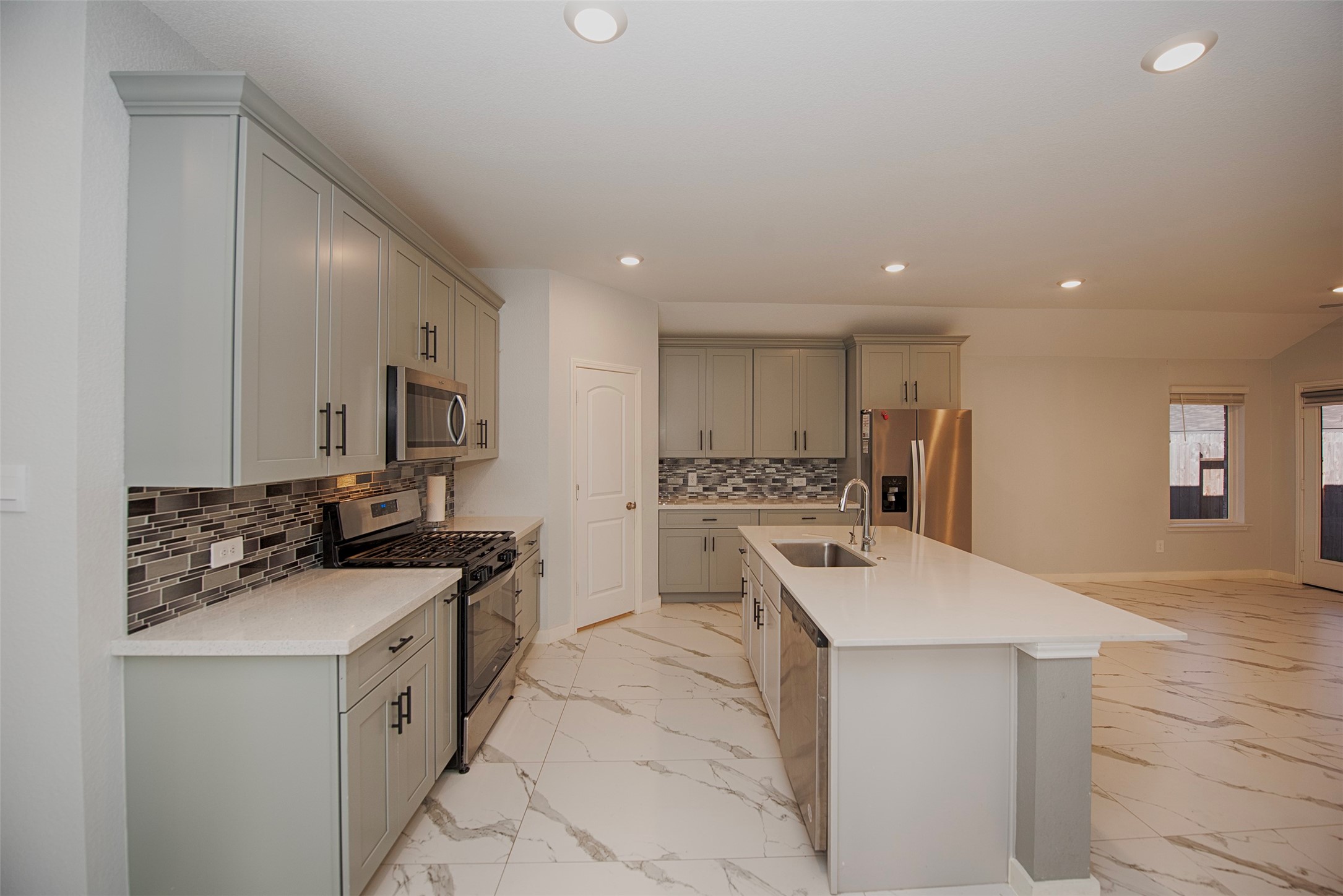 15223 Mayflower Street New Caney, TX 77357 - Photo 11 of 42 a kitchen with a sink stove and cabinets