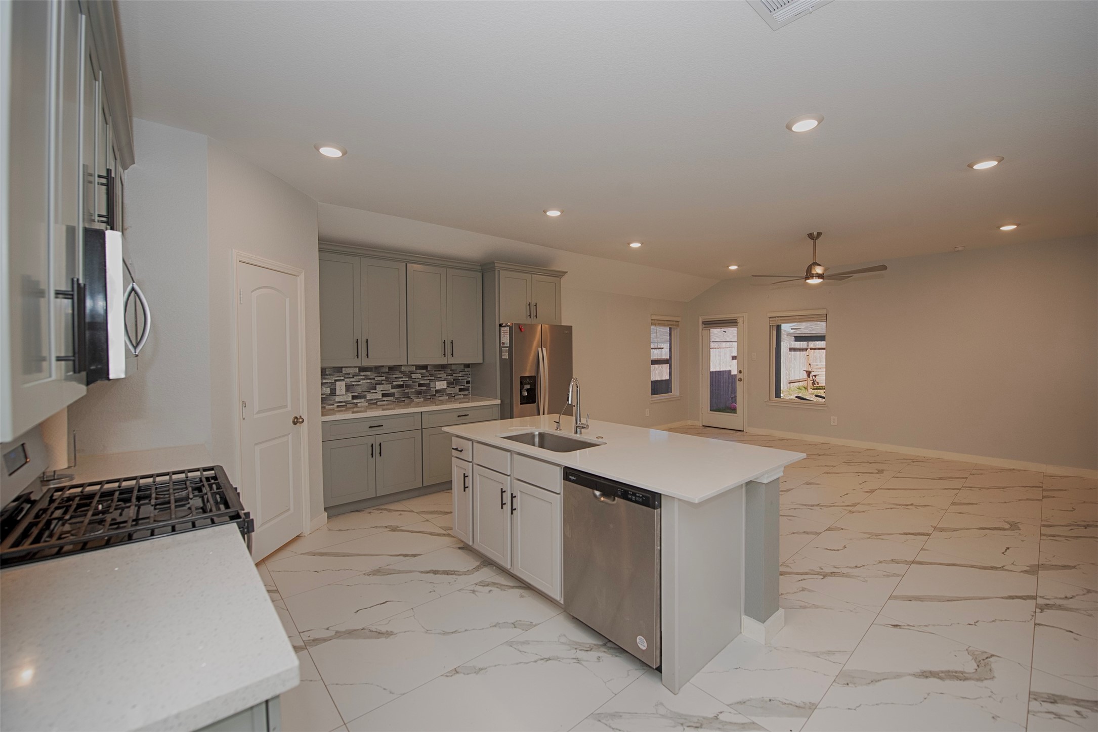 15223 Mayflower Street New Caney, TX 77357 - Photo 12 of 42 a kitchen with a sink stove and cabinets