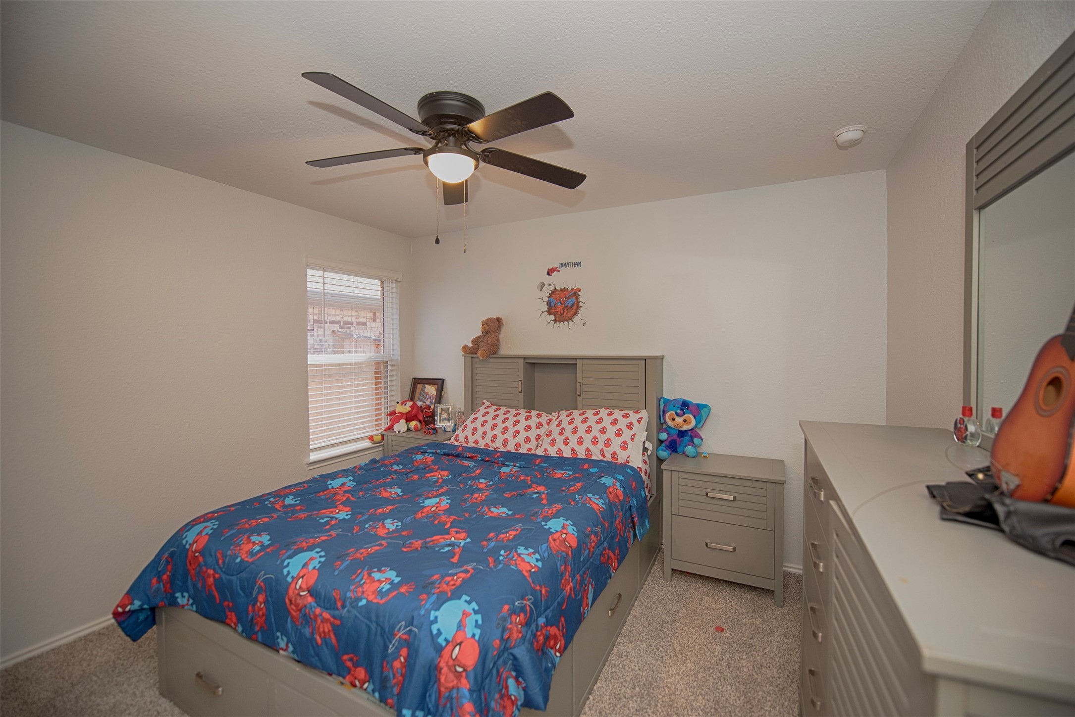 15223 Mayflower Street New Caney, TX 77357 - Photo 24 of 42 a bedroom with a bed and a chandelier