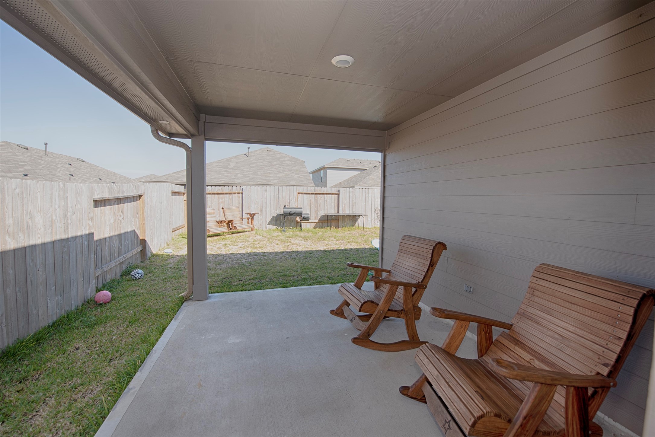 15223 Mayflower Street New Caney, TX 77357 - Photo 36 of 42 a view of a chair and fire pit in backyard of the house