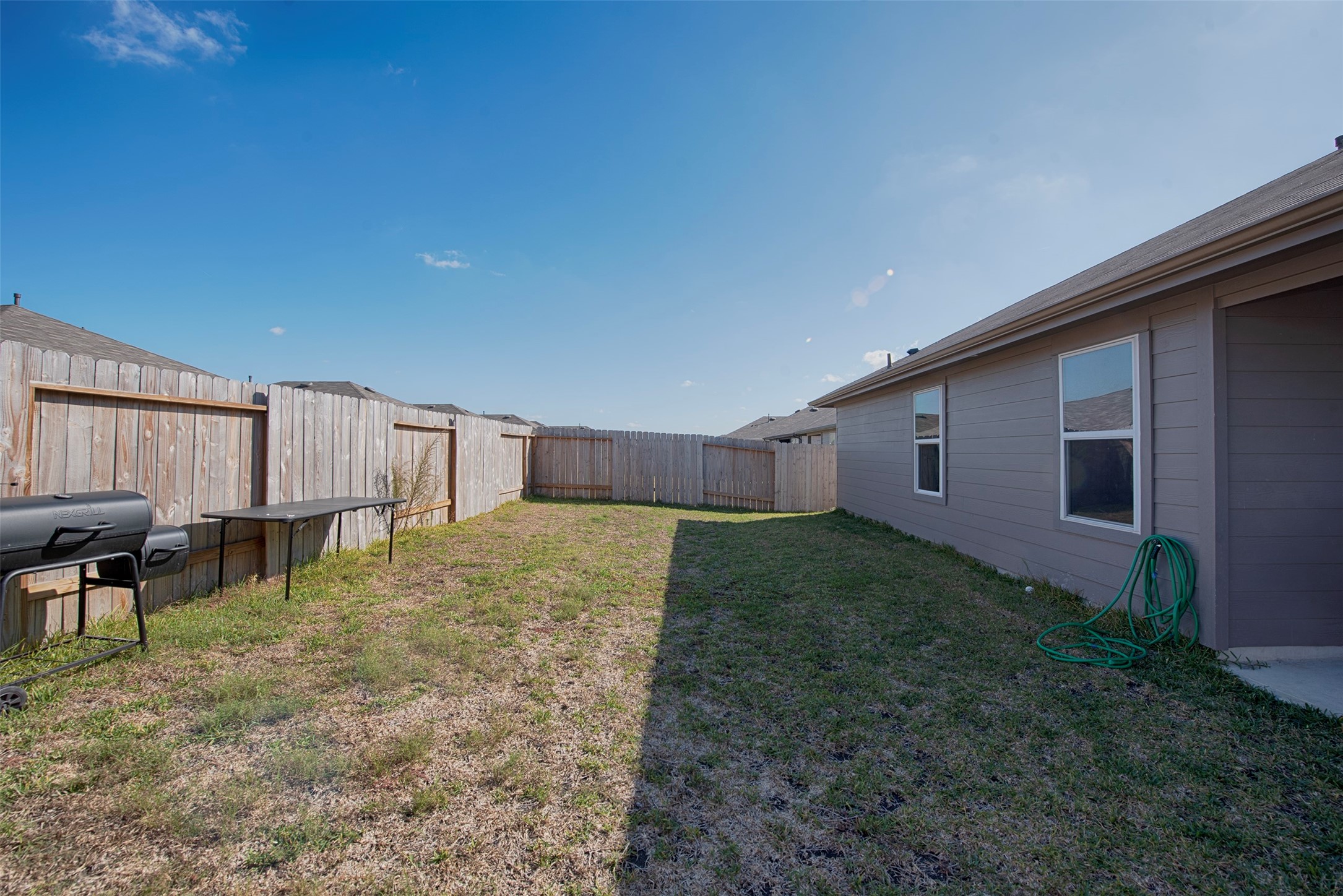 15223 Mayflower Street New Caney, TX 77357 - Photo 38 of 42 a backyard of a house with table and chairs