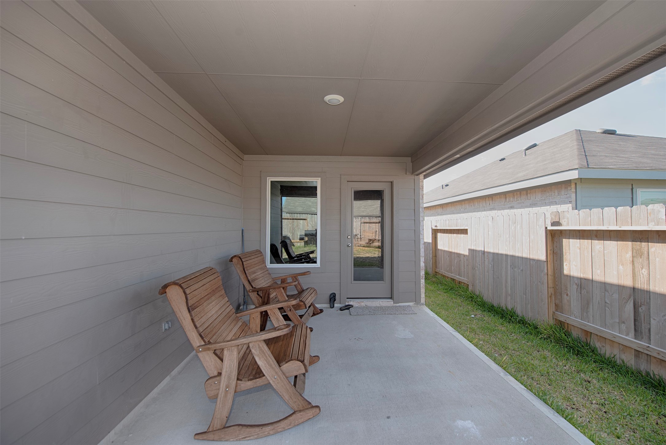 15223 Mayflower Street New Caney, TX 77357 - Photo 39 of 42 a patio with table and chairs and wooden fence