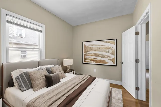 a bedroom with bed and window