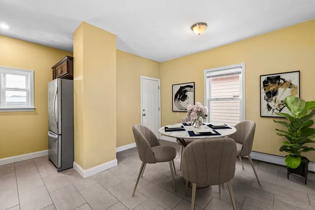 a dining room with furniture and a chandelier