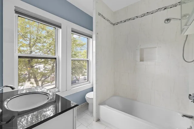 a bath room with a bath tub and a sink