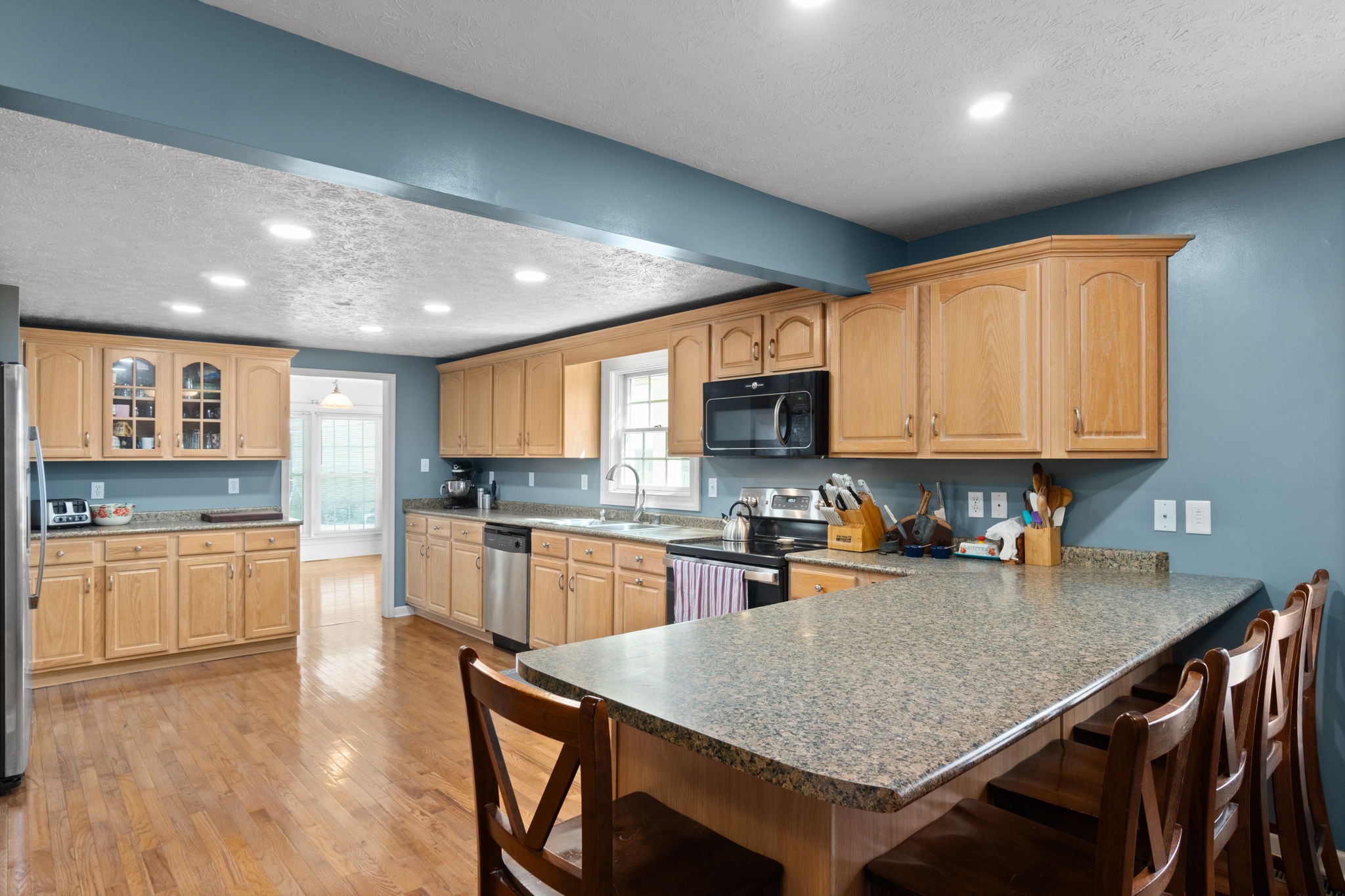 5150 Cadiz Road Hopkinsville, KY 42240 - Photo 12 of 45 a kitchen with granite countertop kitchen island sink stove and cabinets