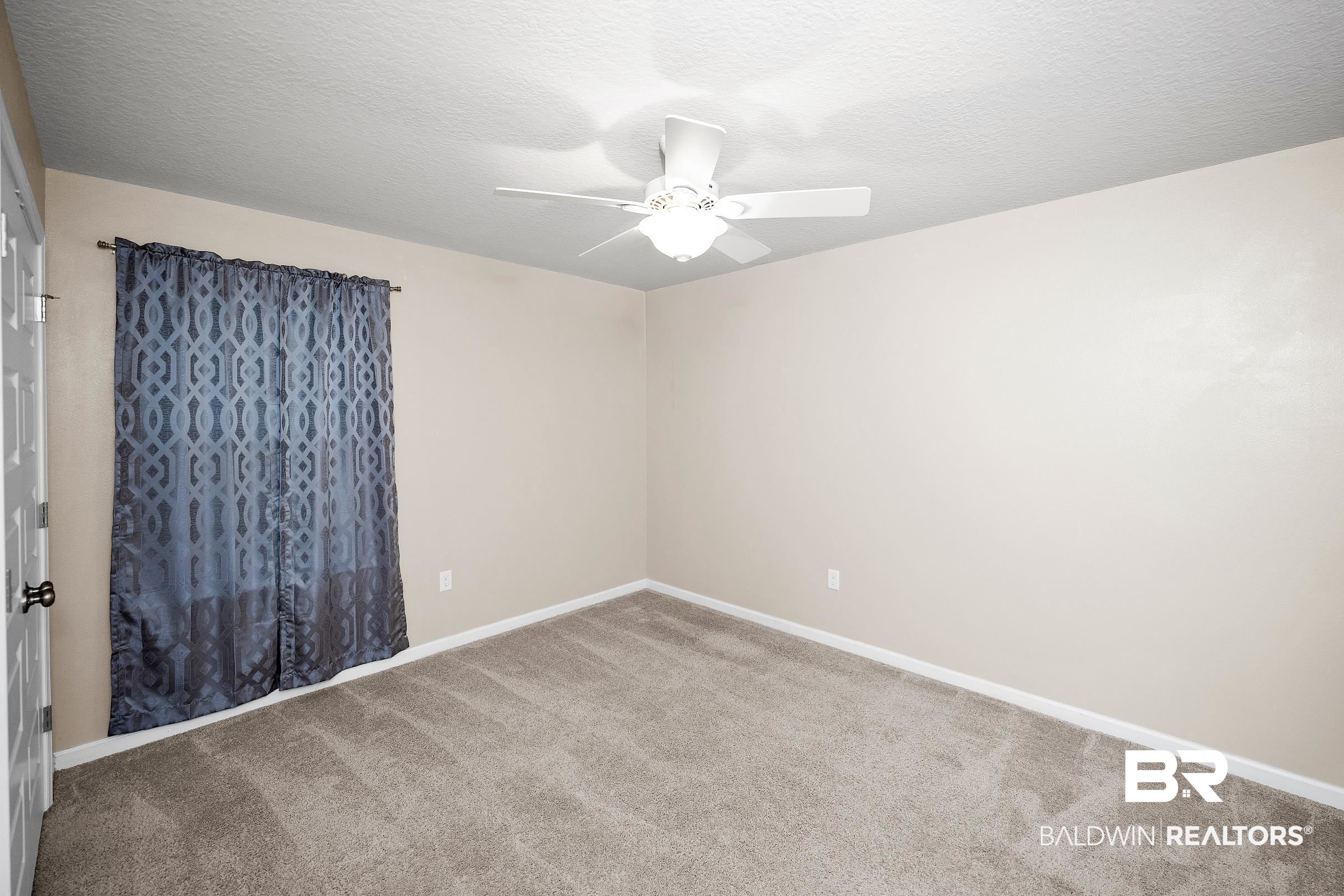 8294 Irwin Loop Daphne, AL 36526 - Photo 20 of 29 Carpeted room with neutral-toned walls
