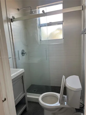 a bathroom with a toilet and a shower