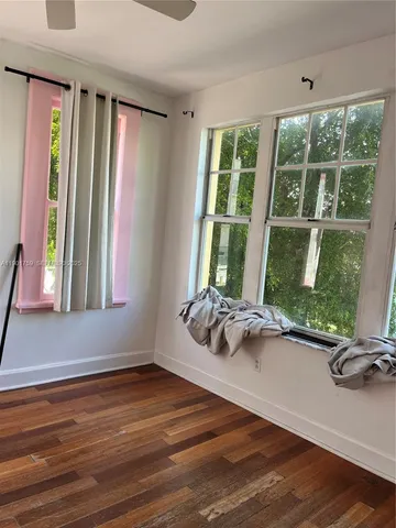 a view of a room with gym equipment and floor to ceiling window