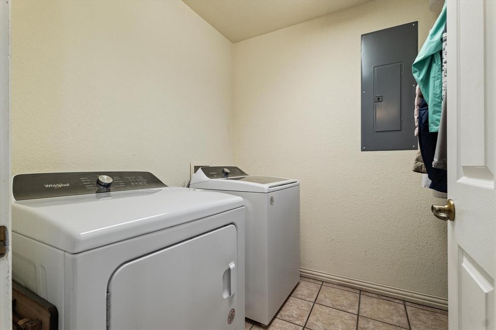 20175 Willow Glade Circle Pilot Point, TX 76258 - Photo 23 of 32 Washroom with electric panel, washer and clothes dryer, and light tile patterned floors