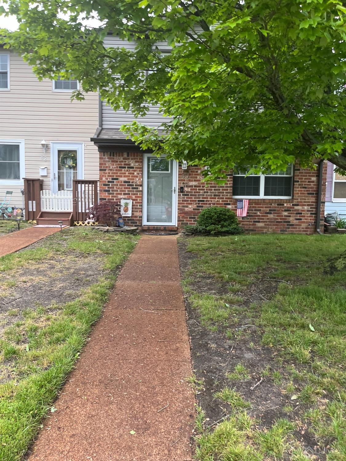 80 Greenwood Loop Road, Unit 80 Brick, NJ 08724 - Photo 1 of 38 a front view of a house with a garden and trees