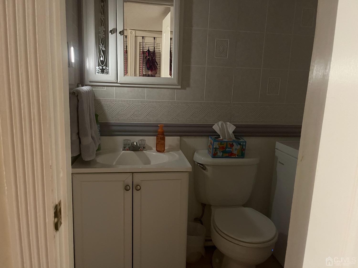 80 Greenwood Loop Road, Unit 80 Brick, NJ 08724 - Photo 15 of 38 a bathroom with a toilet sink and mirror