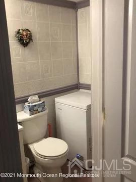 80 Greenwood Loop Road, Unit 80 Brick, NJ 08724 - Photo 17 of 38 a white toilet sitting next to a bathroom sink