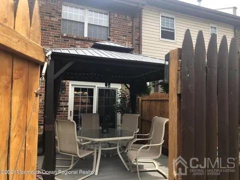80 Greenwood Loop Road, Unit 80 Brick, NJ 08724 - Photo 19 of 38 a front view of a house with outdoor seating and a potted plant
