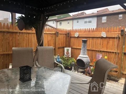 80 Greenwood Loop Road, Unit 80 Brick, NJ 08724 - Photo 21 of 38 a view of balcony with chairs and wooden fence