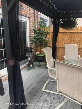 80 Greenwood Loop Road, Unit 80 Brick, NJ 08724 - Photo 23 of 38 a view of balcony with wooden floor and outdoor seating
