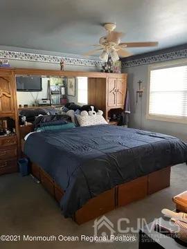 80 Greenwood Loop Road, Unit 80 Brick, NJ 08724 - Photo 25 of 38 a bedroom with a bed mirror and window