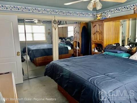 80 Greenwood Loop Road, Unit 80 Brick, NJ 08724 - Photo 26 of 38 a bed sitting in a bedroom next to a window