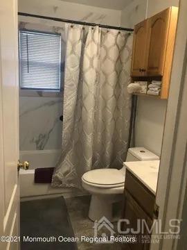 80 Greenwood Loop Road, Unit 80 Brick, NJ 08724 - Photo 29 of 38 a bathroom with a toilet and a shower